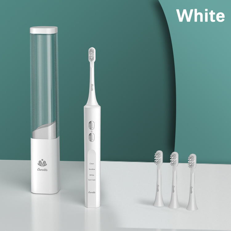 a white electric toothbrush and a tube