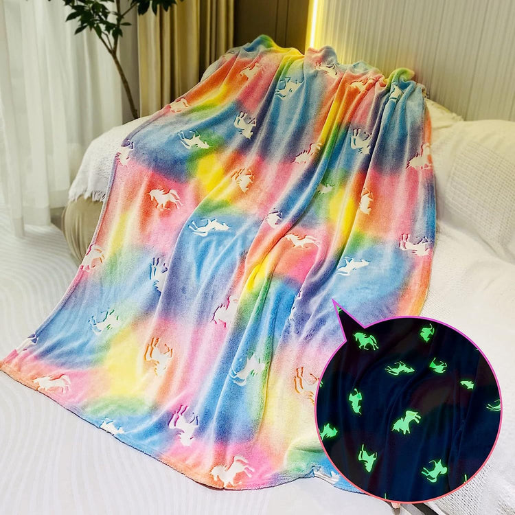 a colorful blanket with unicorns on it