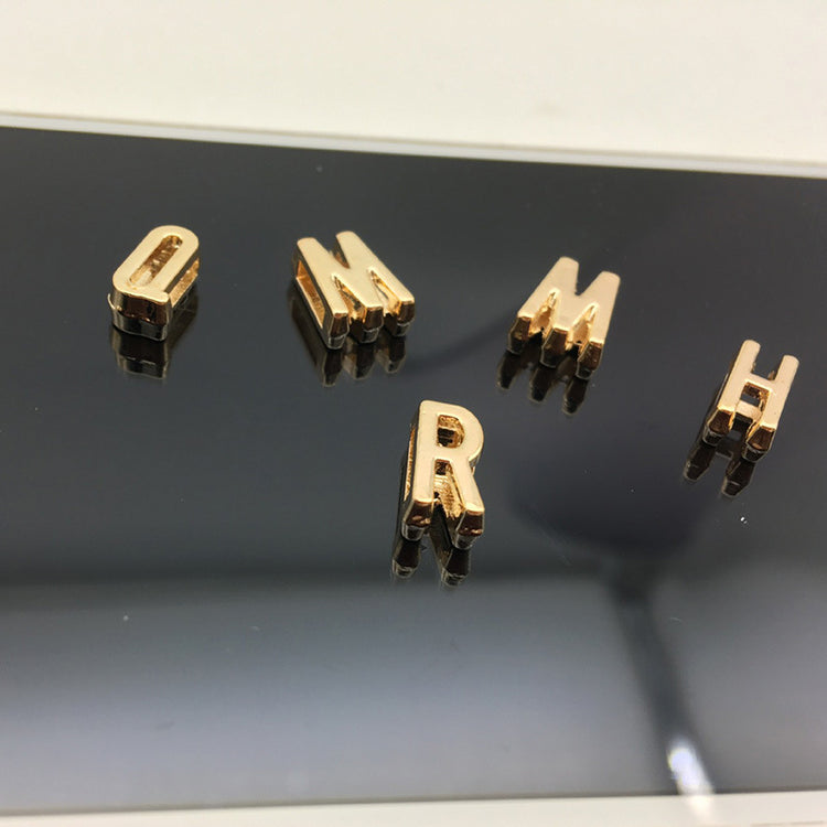 a close up of gold letters on a black surface