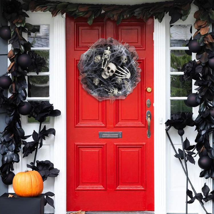 a red door with a wreath and black flowers
