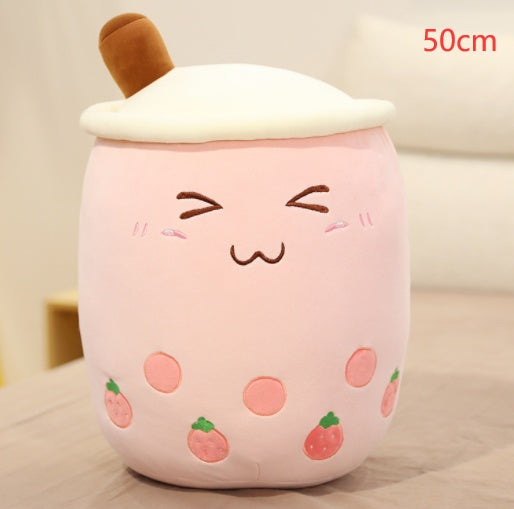 a pink stuffed animal with a face
