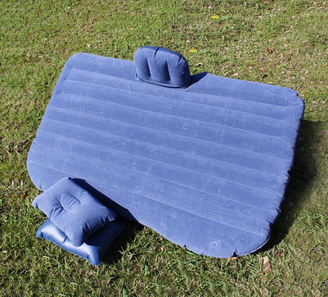 a blue inflatable mattress on grass