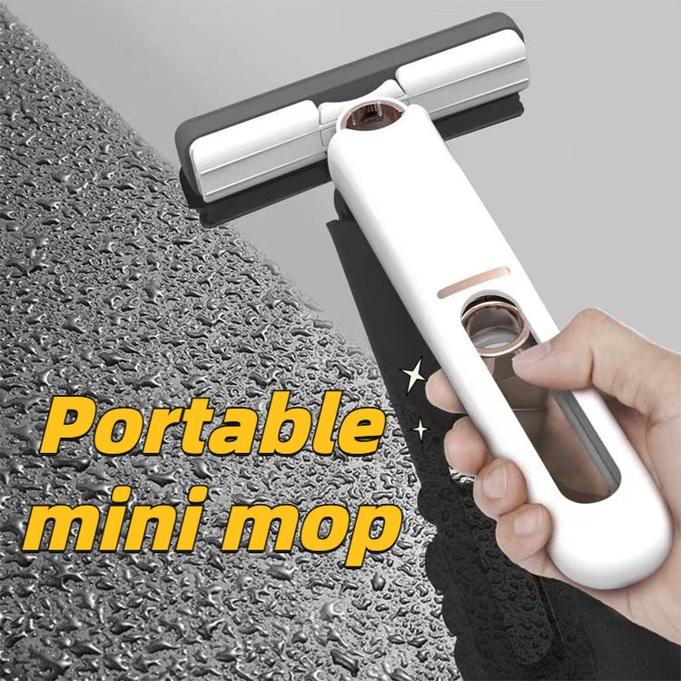 a hand holding a white and black mop