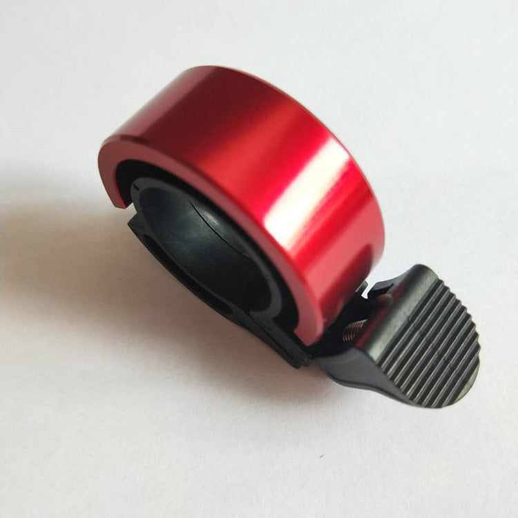 a red tape dispenser with a clip