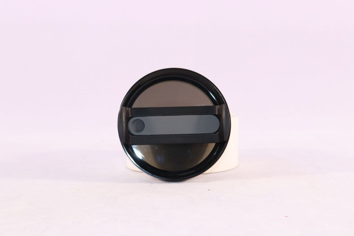 a black round object with a black handle