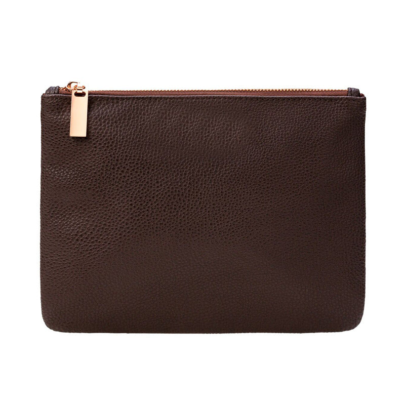 a brown leather pouch with a gold zipper