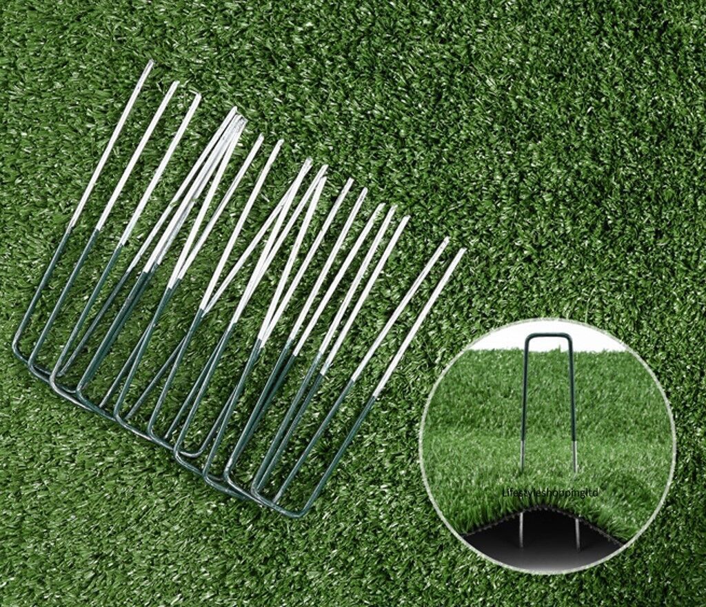 a group of metal pins on a green grass surface