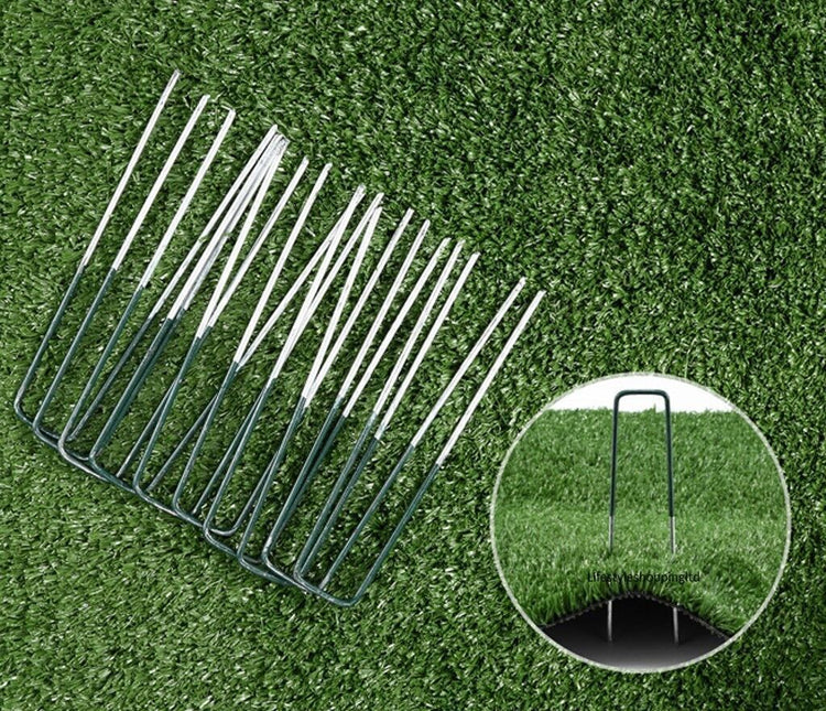 a group of metal pins on a green grass surface