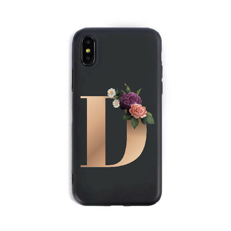 a black phone case with a gold letter and flowers