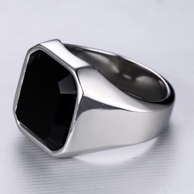 a silver ring with a black stone