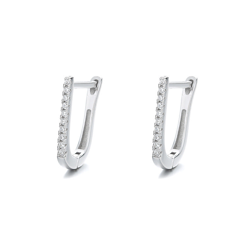 a pair of silver earrings with diamonds