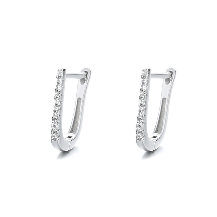 a pair of silver earrings with diamonds