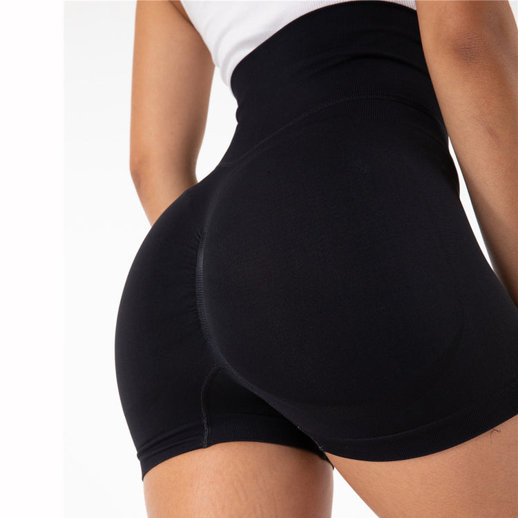 a woman wearing black shorts