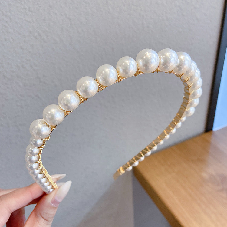 a hand holding a headband