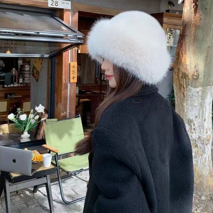 a woman wearing a white hat and coat