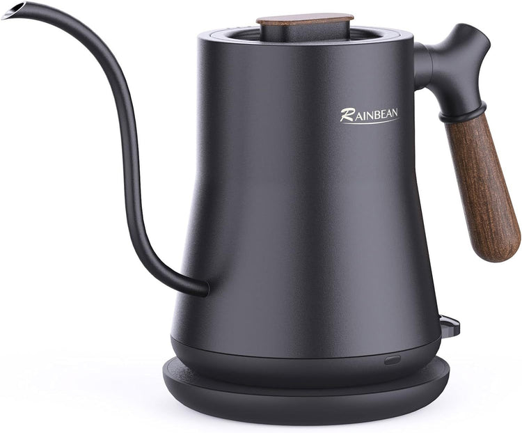 a black kettle with a wooden handle