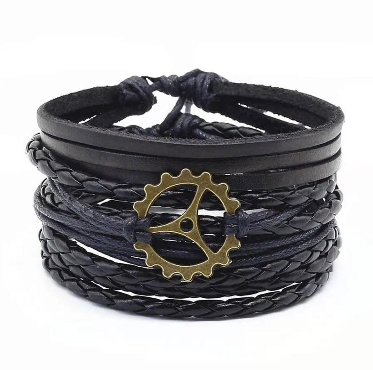 a black leather bracelet with a gold gear on it