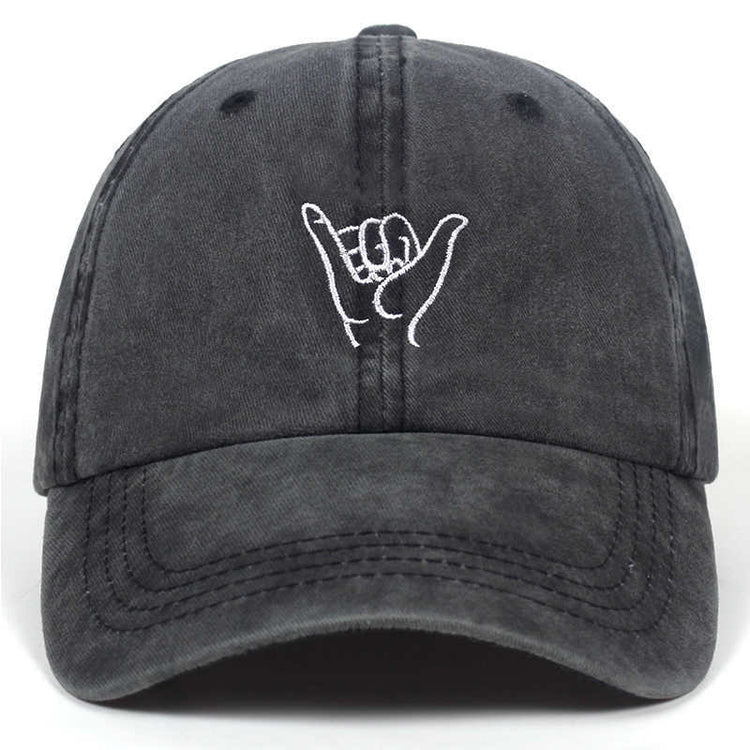 a black baseball cap with a hand gesture on it