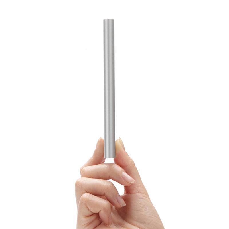 a hand holding a silver object