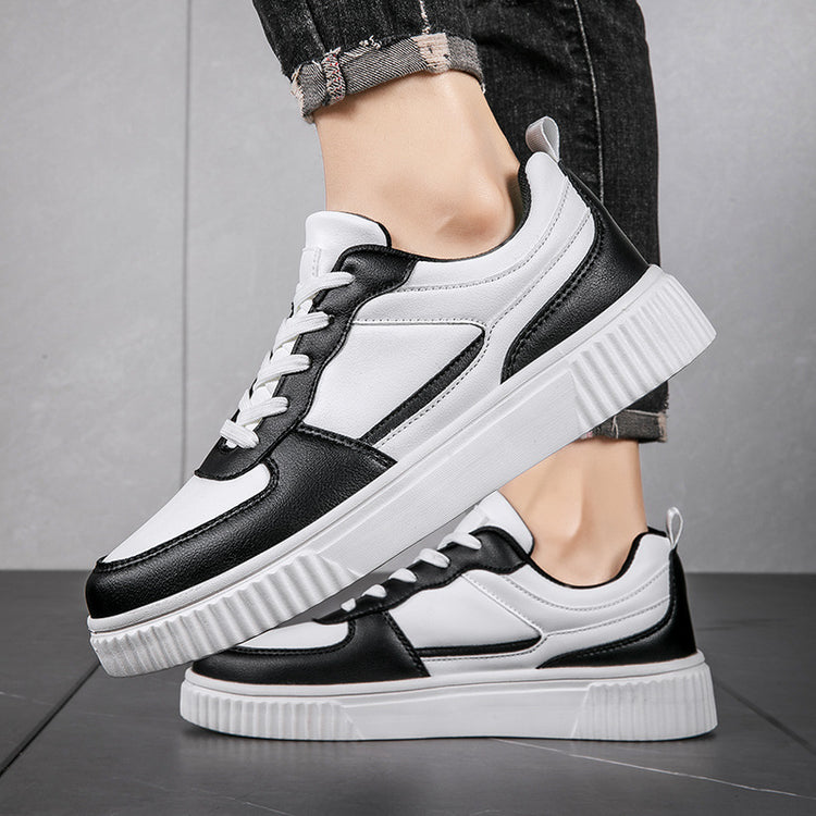 a person's feet wearing black and white sneakers