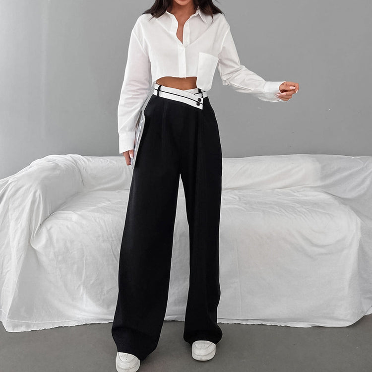 a woman in a white shirt and black pants