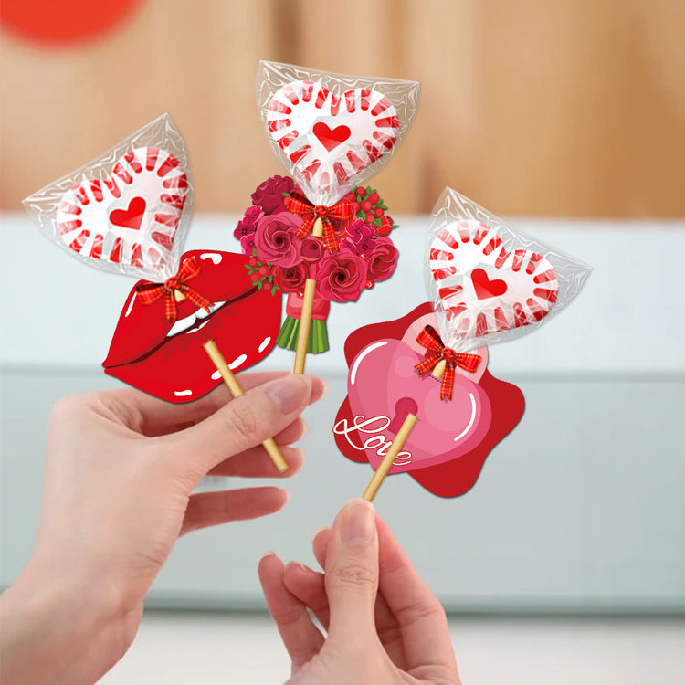 a hand holding a couple of lollipops