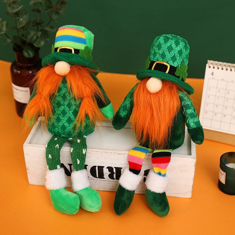 two stuffed leprechauns sitting on a white box