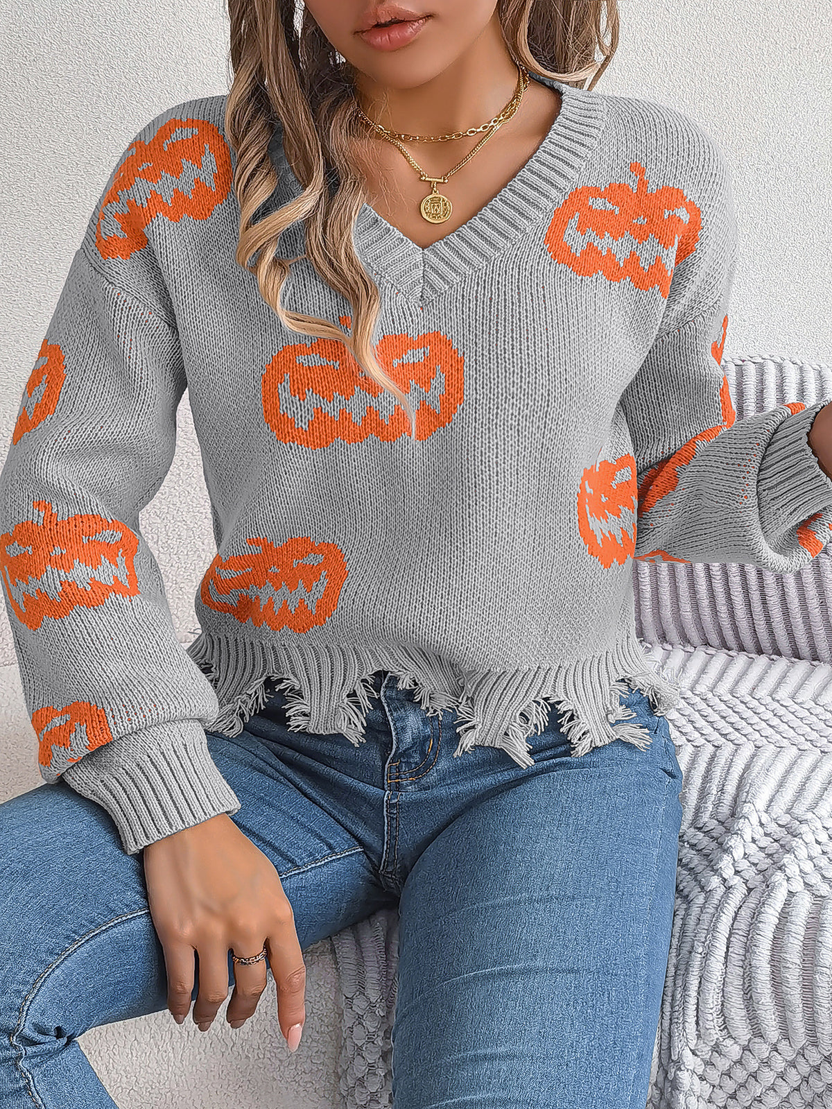 a woman wearing a sweater and jeans