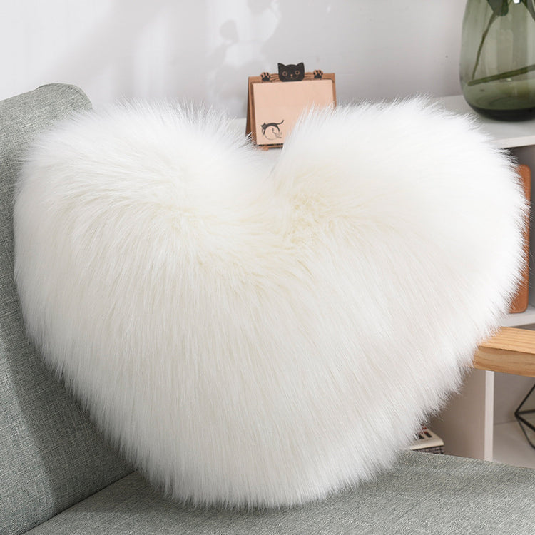 a white fluffy pillow on a couch