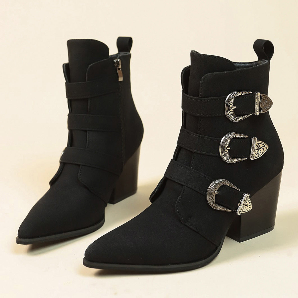 a pair of black boots with silver buckles