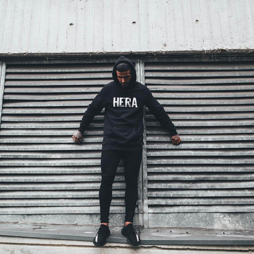 a man leaning against a metal shutter