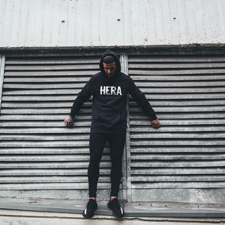 a man leaning against a metal shutter