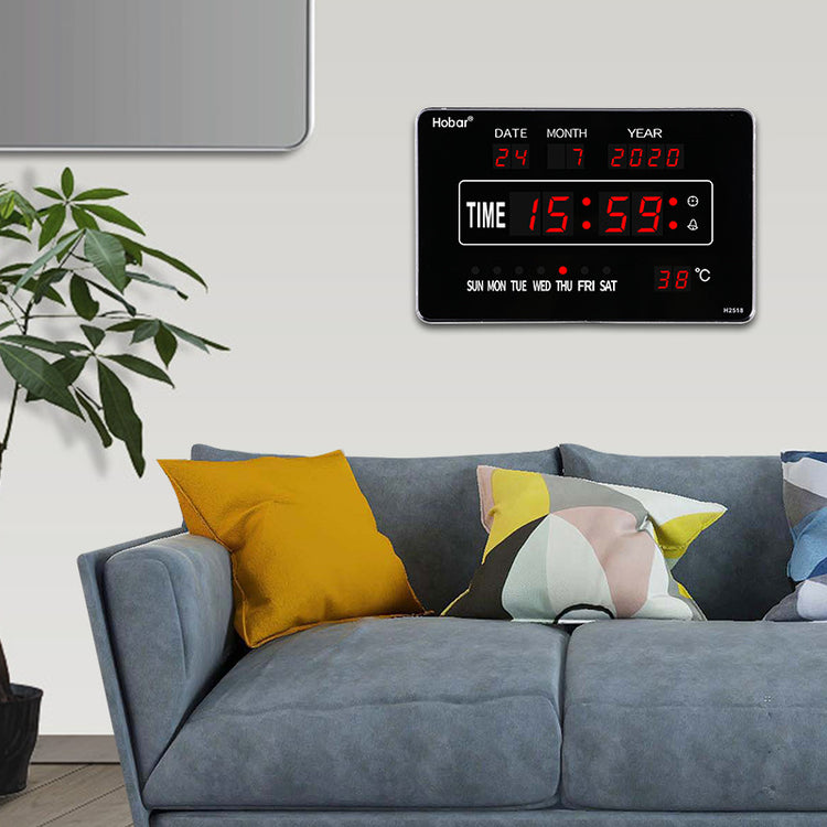 a couch with pillows and a digital clock