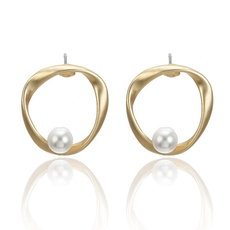 a pair of gold earrings with a pearl in the middle