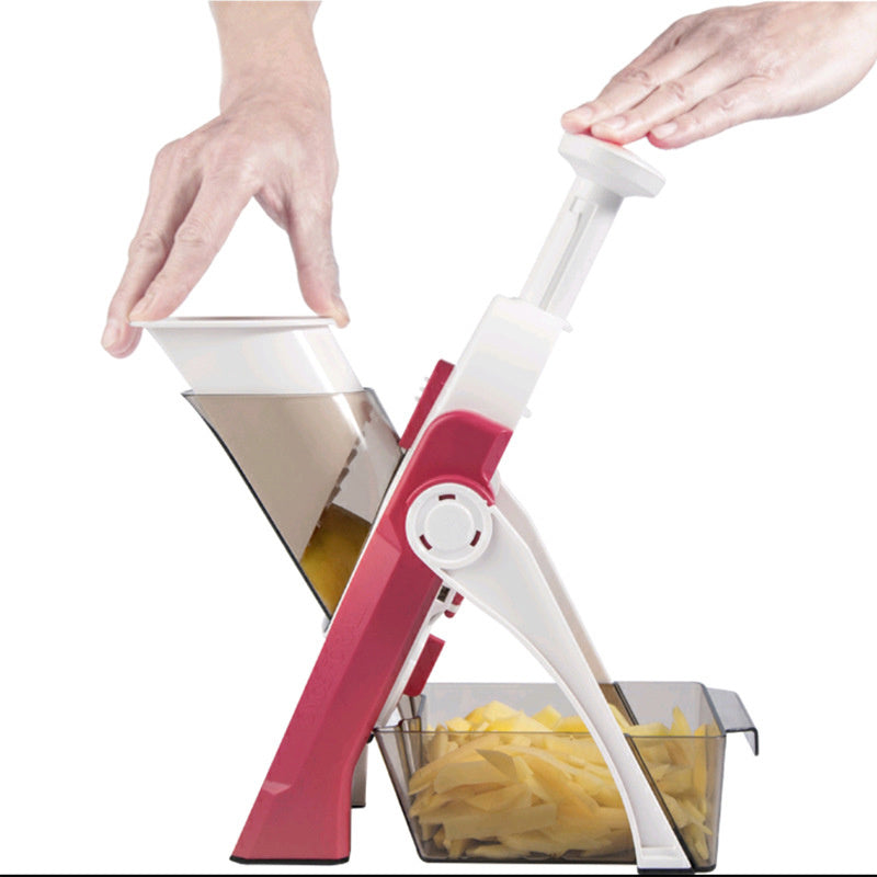 a hand on a vegetable peeler