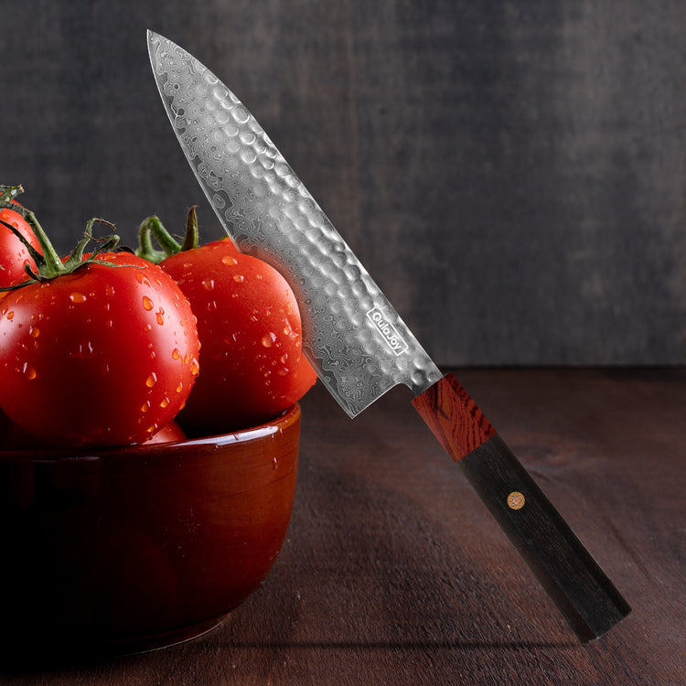 a knife on a bowl of tomatoes