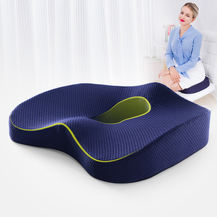 a woman sitting on a chair with a pillow