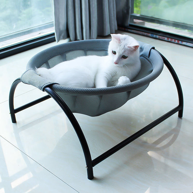 a white cat lying in a small basket