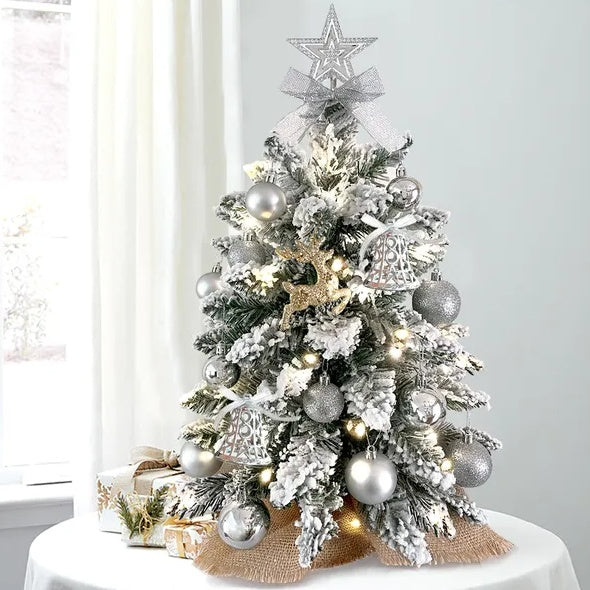 a small christmas tree with silver ornaments and lights