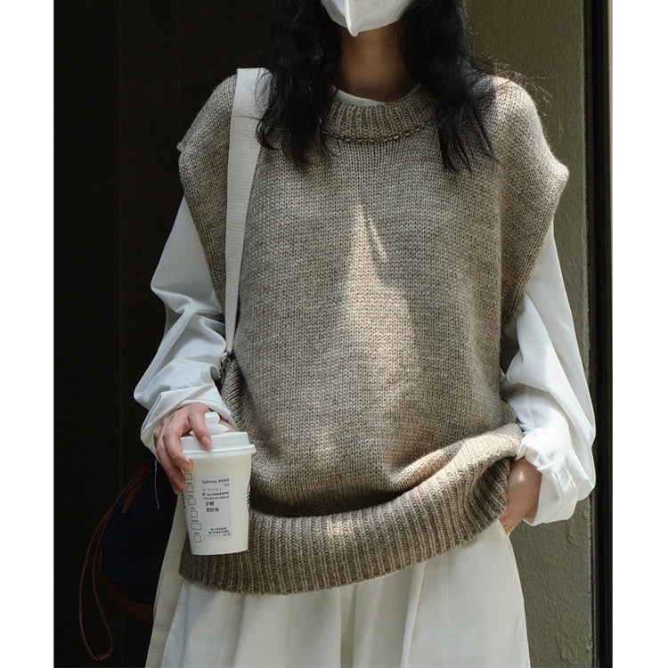 a woman wearing a face mask and holding a coffee cup