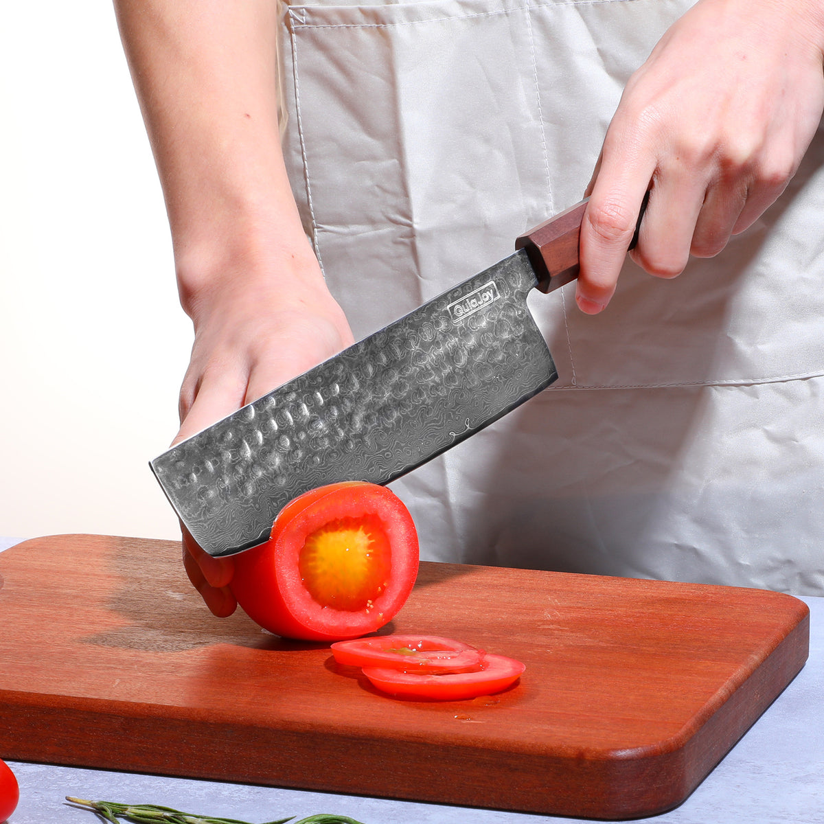 a person cutting a tomato with a knife