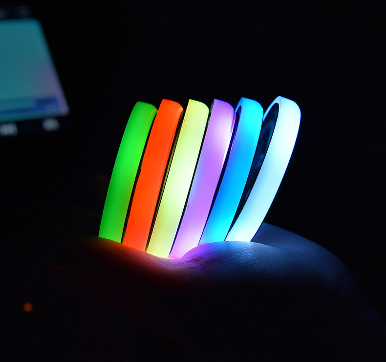 a hand holding colorful bracelets