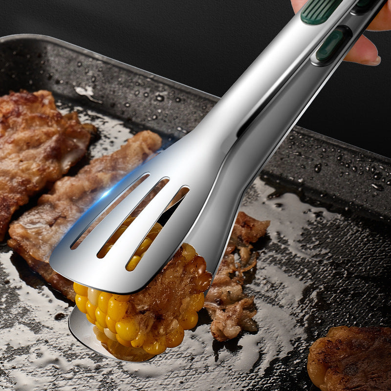 a tong with a corn on the cob being cooked on a pan
