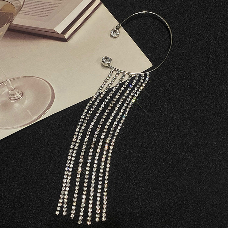 a necklace with long fringes and a glass of wine
