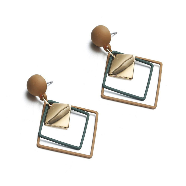 a pair of earrings with square shaped metal and green squares