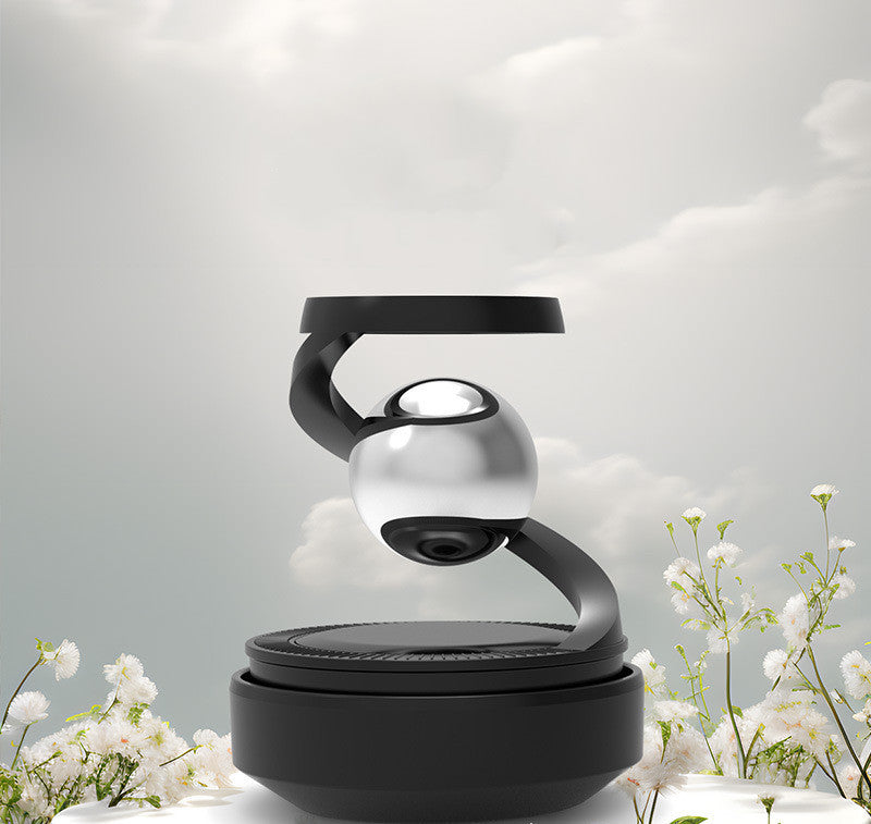 a black and silver object with a round object on top