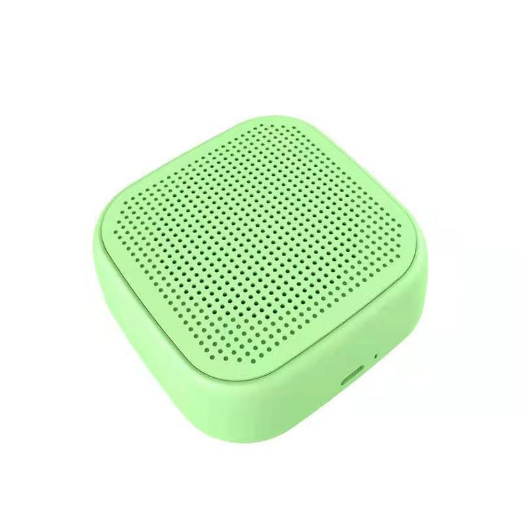 a green square speaker with holes