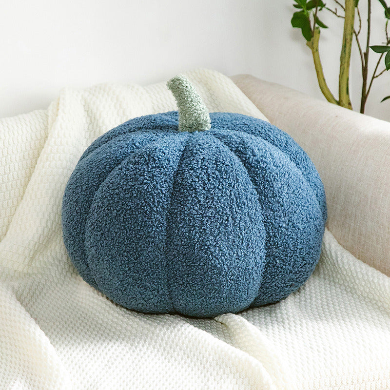 a blue pumpkin on a white blanket