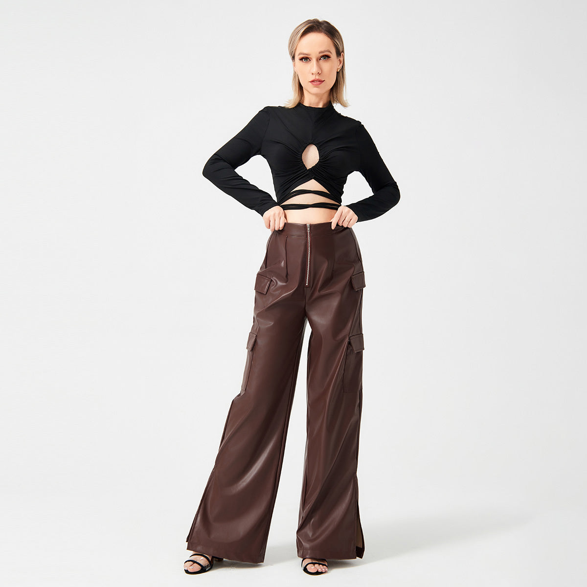 a woman in black top and brown pants