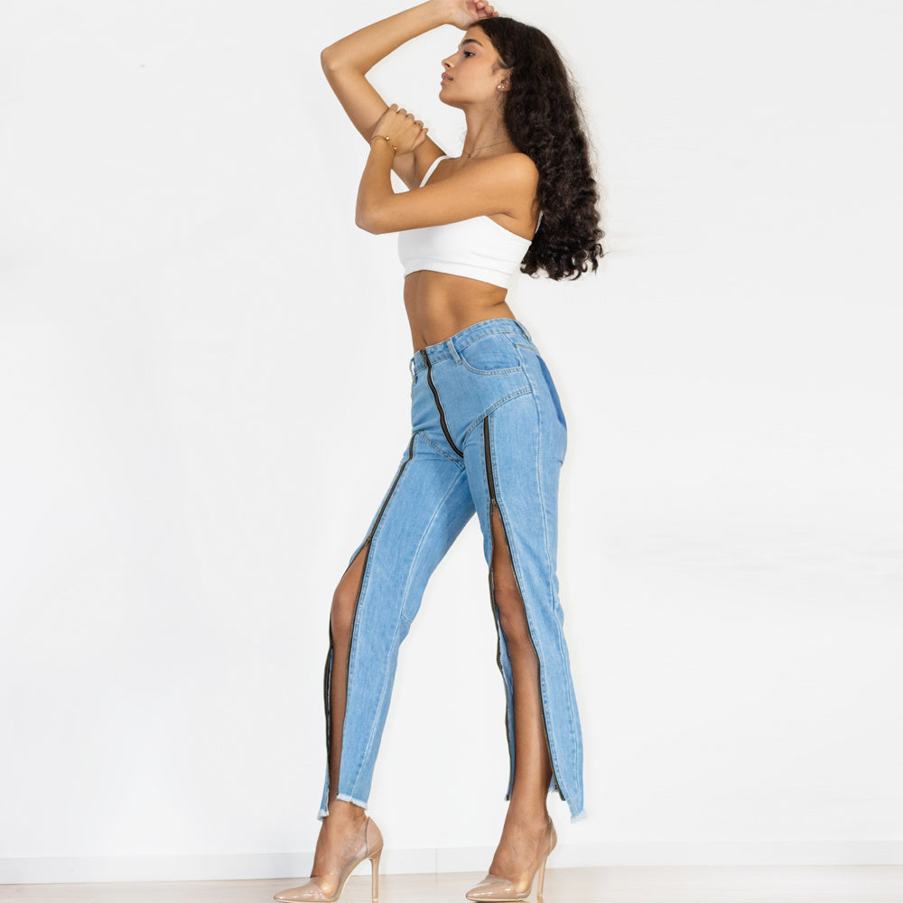 a woman in a white top and blue jeans